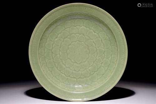 A Chinese celadon dish with incised lotus design, 19th C.