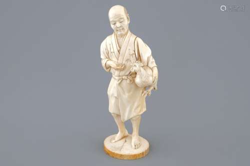 A Japanese ivory okimono of a chicken farmer, Meiji, 19th C., signed