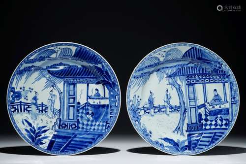 A pair of Chinese blue and white chargers with a scene from 