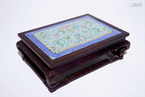 A Chinese famille rose enamel tile plaque mounted in a wood stand, 19th C.