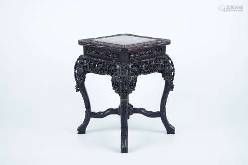 An intricately carved square Chinese wood stand with marble top, 19th C.