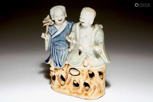 A Chinese celadon and blue-white glazed group of the Hehe Er Xian twins, Qianlong