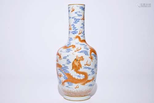 A Chinese iron red and overglaze blue vase with dragons among clouds, 19/20th C.