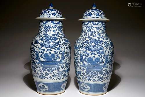 A pair of Chinese blue and white vases and covers, 19th C.