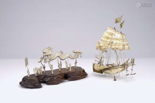 A Chinese silver model of a junk and one of a dragon parade, 19/20th C.