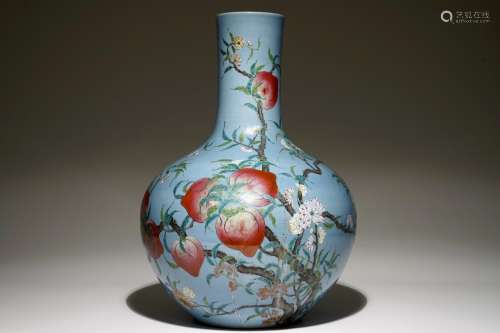 A Chinese famille rose blue ground tianqiuping 'Nine peaches' vase, 19/20th C.