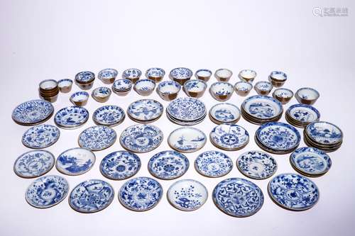 A large collection of Chinese blue and white on capucin brown ground cups and saucers, Kangxi/Qianlong