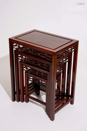 A set of four Chinese sculpted hardwood stacking tables, 20th C.