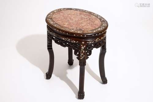 An oval Chinese marble-top mother of pearl inlaid sculpted wood stand, 19th C.