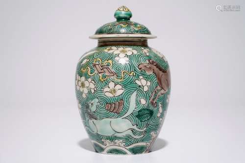 A Chinese verte biscuit covered jar with horses, Kangxi
