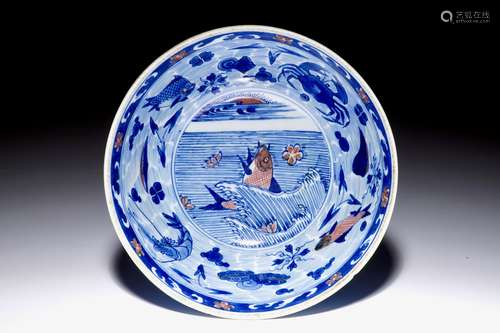 A rare Chinese blue and underglaze red bowl with carps and marine animals, Kangxi mark and of the period