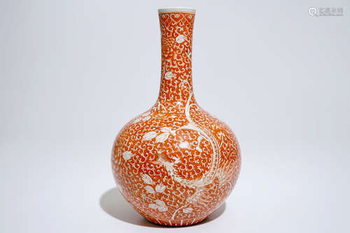 A Chinese iron red and gilt phoenix bottle vase, 19th C.