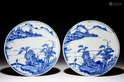 A fine pair of round Chinese blue and white landscape plaques, Kangxi