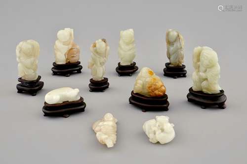 Ten various small jade carvings on wooden bases, 19/20th C.