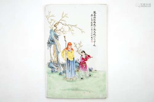 A Chinese famille rose plaque with two figures in a garden, 19/20th C.