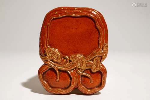 A small Chinese coral-glazed and gilt inkstone, Qianlong mark, 18/19th C.