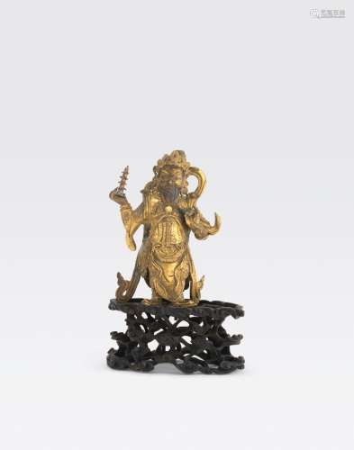 A GILT BRONZE FIGURE OF A GUARDIAN DEITY