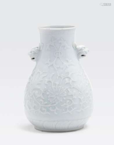 A WHITE GLAZED VASE WITH MOLDED RELIEF DECORATION