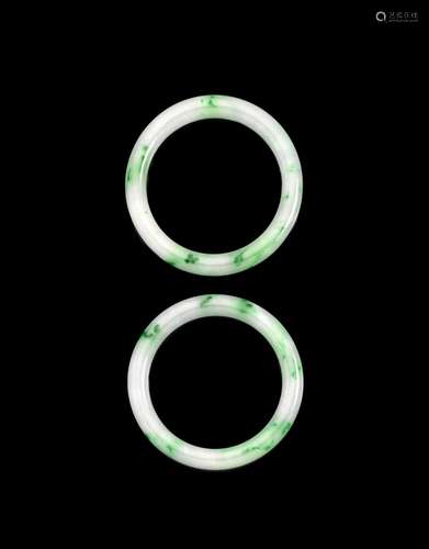 A PAIR OF GREEN AND WHITE JADEITE BANGLES