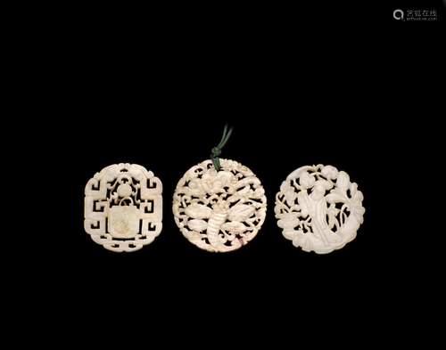 A GROUP OF THREE RETICULATED JADE PENDANTS