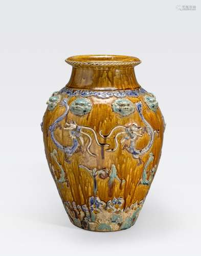 A TALL AMBER GROUND STORAGE JAR WITH POLYCHROMERAISED RELIEF DECORATION