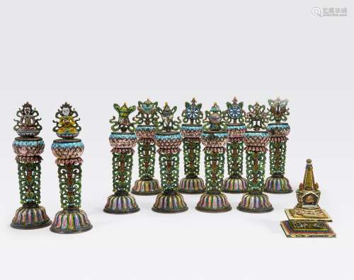 AN ASSEMBLED GROUP OF POLYCHROME ENAMELED SILVER BUDDHIST ALTARORNAMENTS AND A STUPA