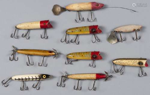 Nine Heddon wood fishing lures, to include three