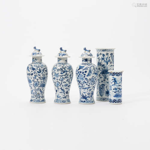 A set of three Chinese blue and white vases and covers and a rouleau vase