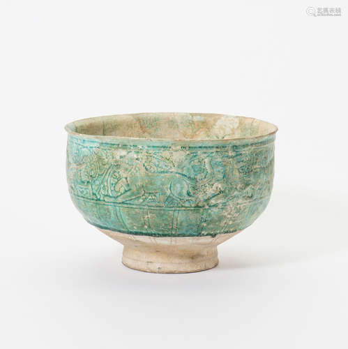 A large Persian turquoise glazed ceramic bowl