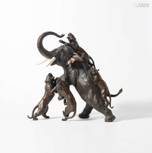 A Japanese bronze sculpture of an elephant and tigers