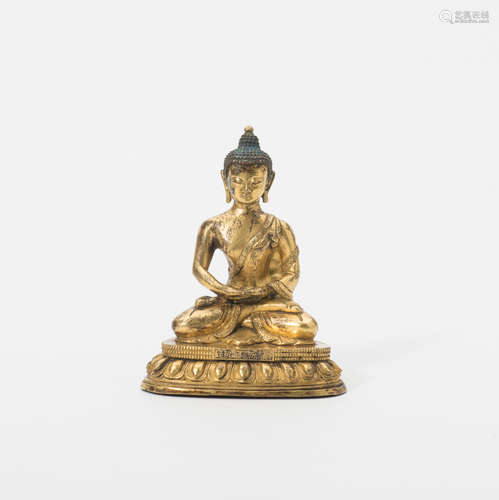 A Chinese gilt-bronze figure of Buddha