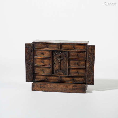 A wallnut, oak and teak cabinet with iron handles