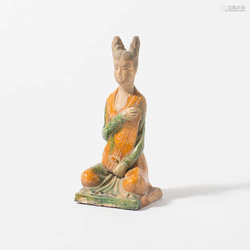 A Chinese earthenware sancai-glazed sculpture of a lady playing lute