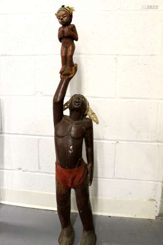 African style Wood statue of a man holding a baby.