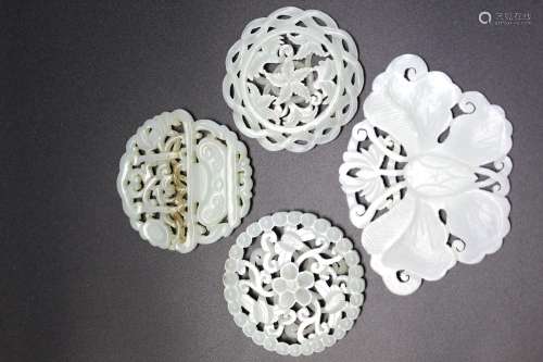 Four Chinese carved jade plaques.
