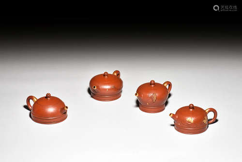 ZHOU GUIZHEN: SET OF FOUR YIXING ZISHA TEAPOTS