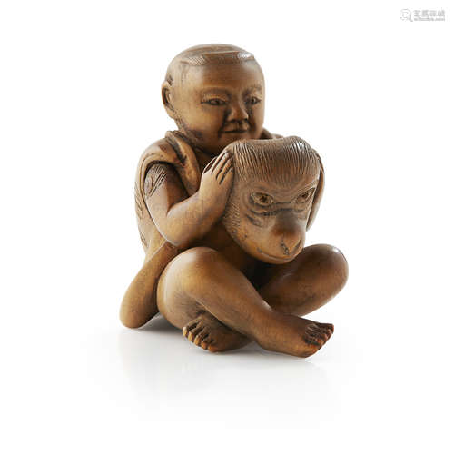 CARVED WOOD KARAKURI-NETSUKE OF A BOY