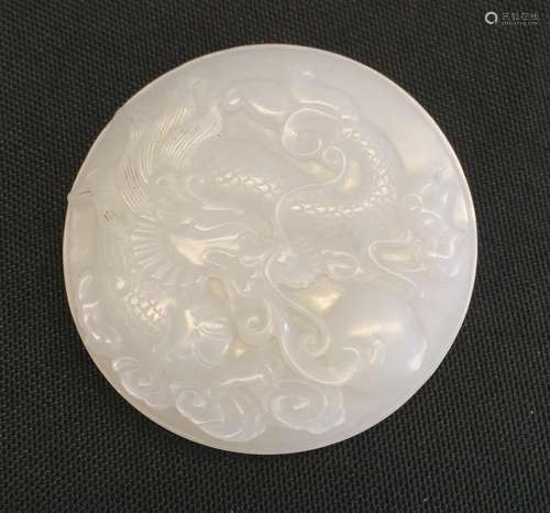 A finely carved Chinese white jade circular Dragon pendant,