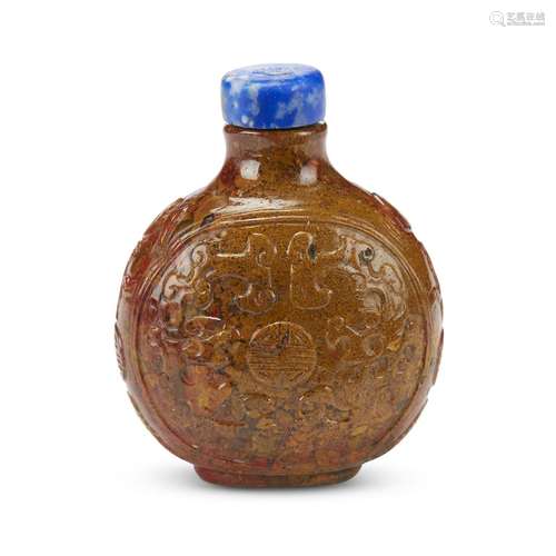 A Chinese jasper snuff bottle carved with shou symbols and archaistic dragons,