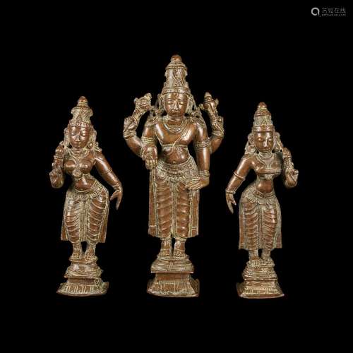 An Indian copper alloy figure of Vishnu and two similar figures of Lakshmi,