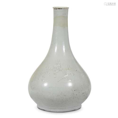 A Korean white porcelain bottle vase with applied prunus spray and bamboo, 18th/19th century