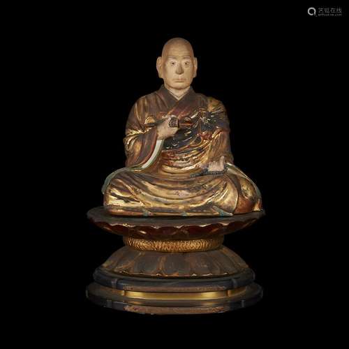 A Japanese carved, painted, lacquered and gilt wood figure of a seated Buddhist monk, Late Edo/early Meiji period