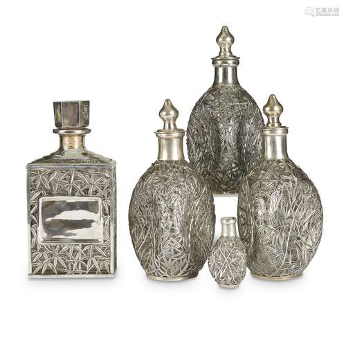 A group of five silver-overlay decanters, probably Chinese,