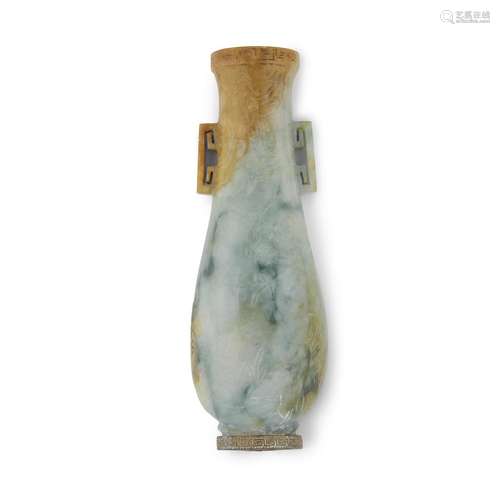 A small Chinese carved green, russet and grey jadeite wall vase with later metal mount at foot,