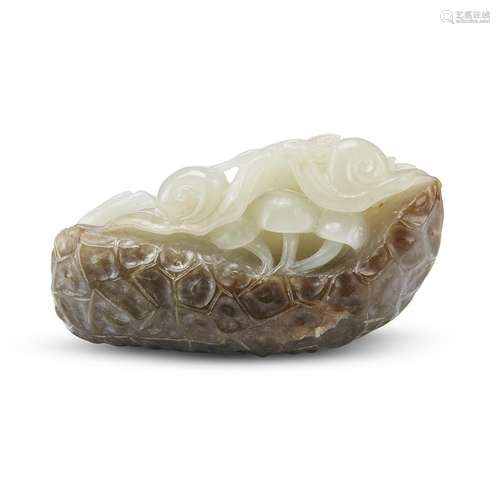 A Chinese carved white and brownish-grey jade Snail, Mushroom, and Pine pendant,