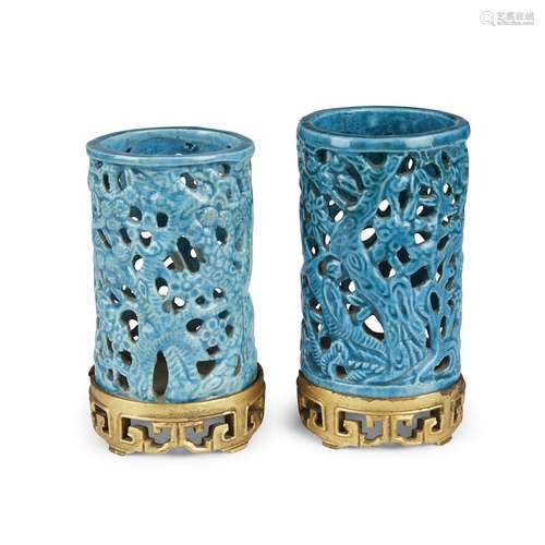 A matched pair of turquoise-glazed pierced cylindrical small brush pots, with later gilt wood stands,