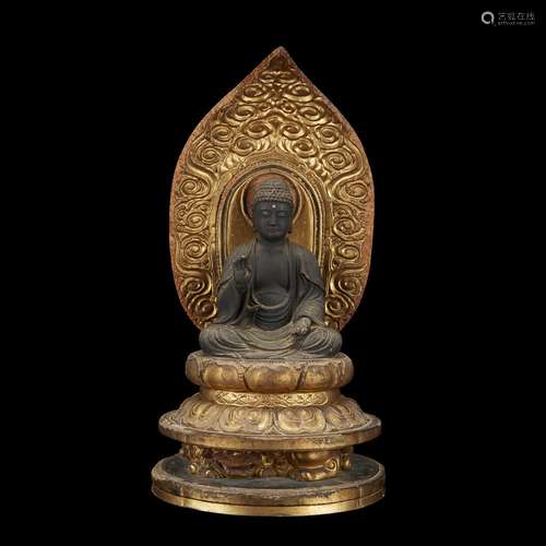 A Japanese carved wood and gilt lacquered figure of Amida Buddha seated, Late Edo/early Meiji period