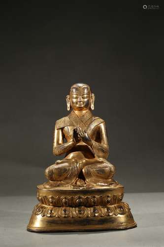 A gilt-bronze figure of guru