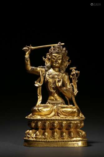 A gilt bronze figure of seated manjusri