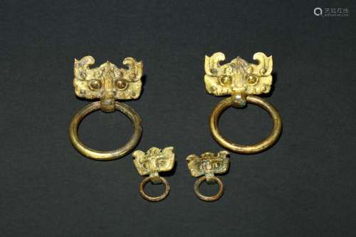 A set of gilt-bronze mythical beast mask fittings